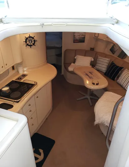  Yacht Photos Pics Interior of 1998 Sea Ray 400 Sundancer yacht with cozy seating and compact kitchen area.