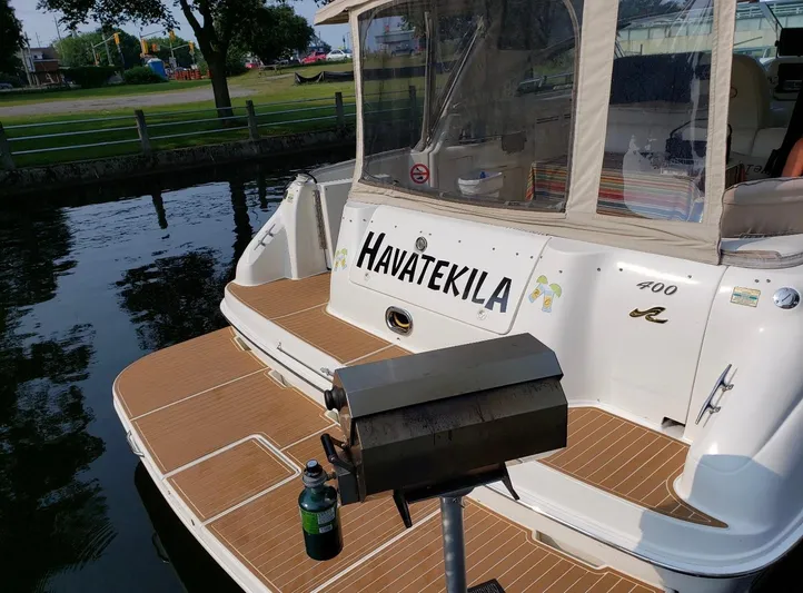  Yacht Photos Pics 1998 Sea Ray 400 Sundancer docked, featuring a grill and beverage on the deck.