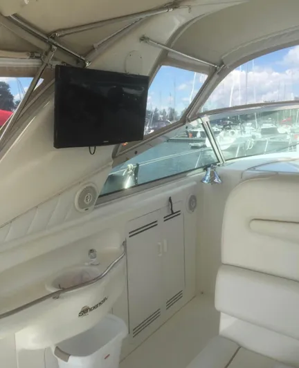  Yacht Photos Pics 1998 Sea Ray 400 Sundancer interior with white seating and mounted TV.