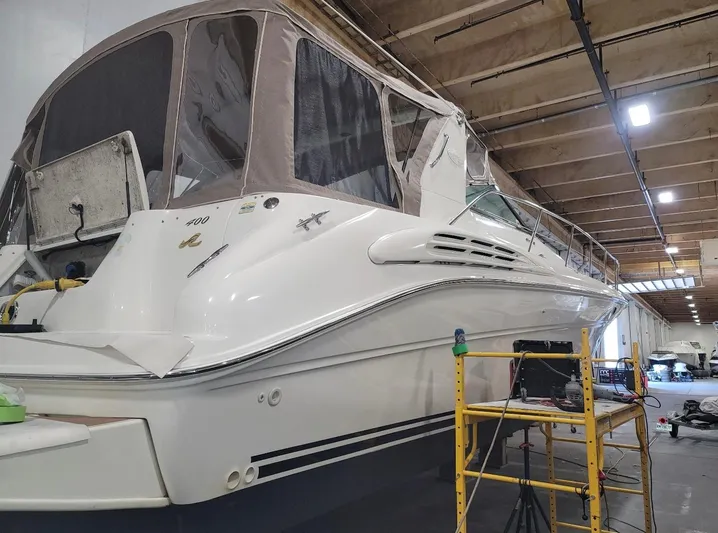  Yacht Photos Pics 1998 Sea Ray 400 Sundancer yacht in a workshop, undergoing maintenance.