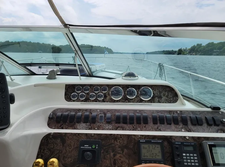  Yacht Photos Pics Cockpit view of a 1998 Sea Ray 400 Sundancer cruising on a scenic lake.