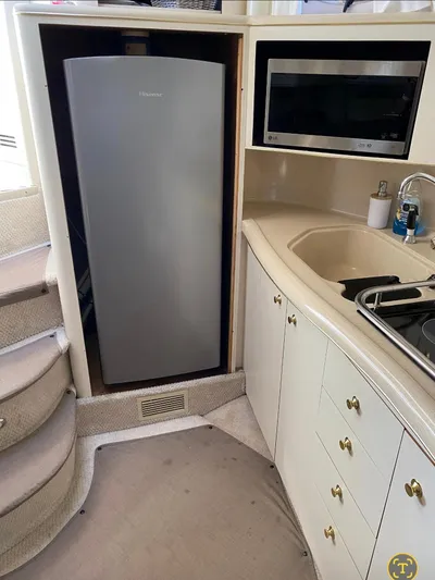 Yacht Photos Pics 1998 Sea Ray 400 Sundancer kitchen with fridge, microwave, and sink.