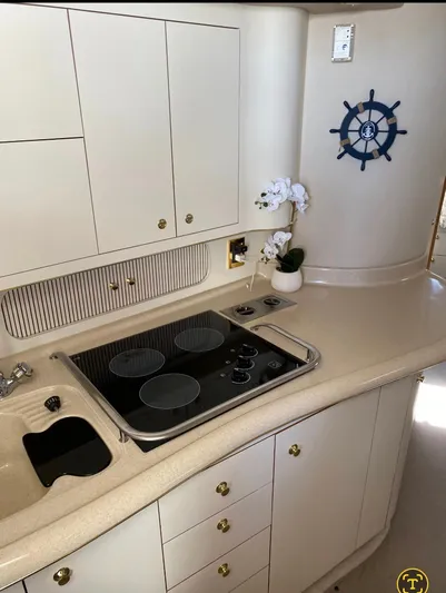  Yacht Photos Pics 1998 Sea Ray 400 Sundancer yacht kitchen with stove, cabinets, and nautical decor.