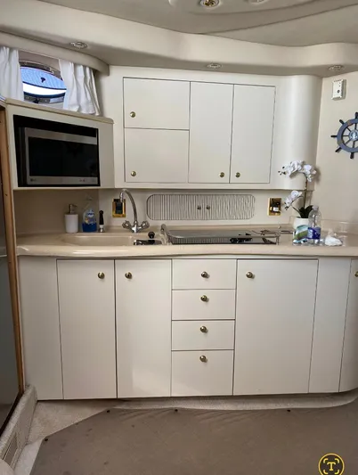  Yacht Photos Pics 1998 Sea Ray 400 Sundancer yacht kitchen with white cabinets and modern appliances.