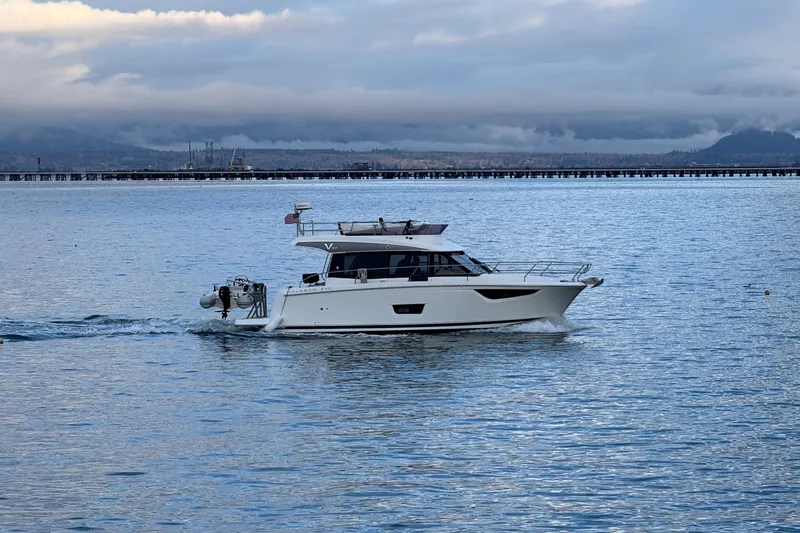  Yacht Photos Pics 2019 Jeanneau Velasco 37F cruising on calm waters under cloudy skies.