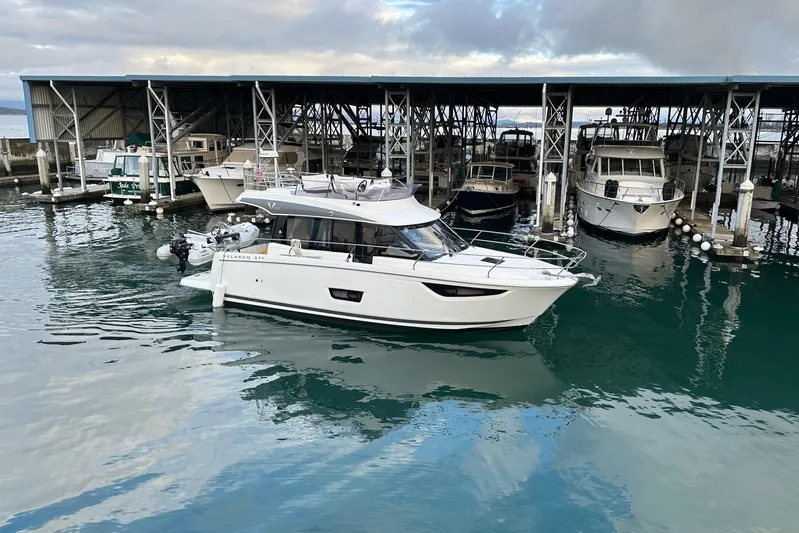  Yacht Photos Pics 2019 Jeanneau Velasco 37F yacht docked in marina, calm water reflections.