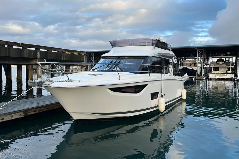  Yacht Photos Pics 2019 Jeanneau Velasco 37F yacht docked in marina, reflecting on calm water.