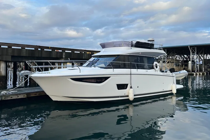  Yacht Photos Pics 2019 Jeanneau Velasco 37F yacht docked at marina, calm waters, overcast sky.
