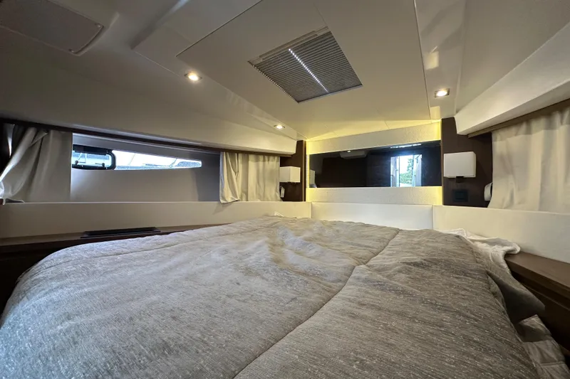  Yacht Photos Pics Luxurious cabin interior of 2019 Jeanneau Velasco 37F yacht with cozy bedding.