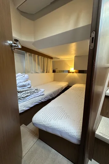  Yacht Photos Pics Cozy cabin interior of 2019 Jeanneau Velasco 37F with twin beds and soft lighting.