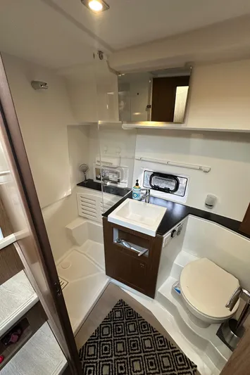  Yacht Photos Pics Modern bathroom in 2019 Jeanneau Velasco 37F yacht with sink, toilet, and storage.