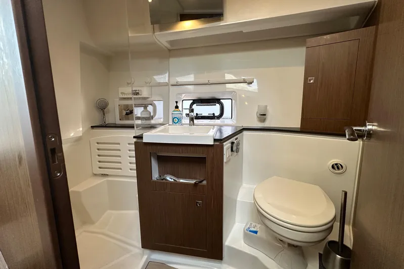 Yacht Photos Pics 2019 Jeanneau Velasco 37F yacht bathroom with modern fixtures and wood accents.