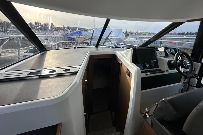  Yacht Photos Pics Interior view of 2019 Jeanneau Velasco 37F yacht cockpit with steering wheel and navigation equipment.
