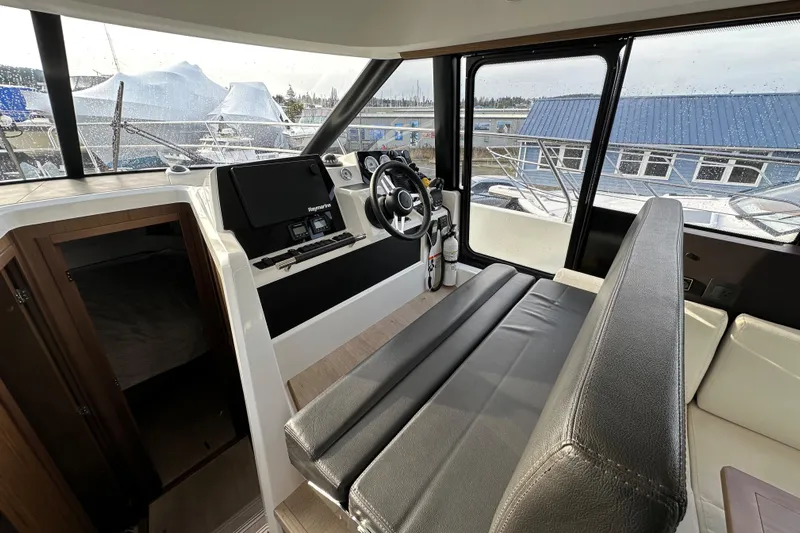  Yacht Photos Pics Interior of 2019 Jeanneau Velasco 37F yacht with modern helm and seating.