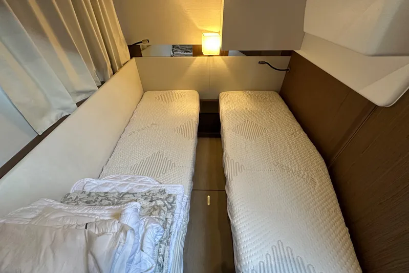  Yacht Photos Pics Interior cabin of 2019 Jeanneau Velasco 37F with twin beds and soft lighting.
