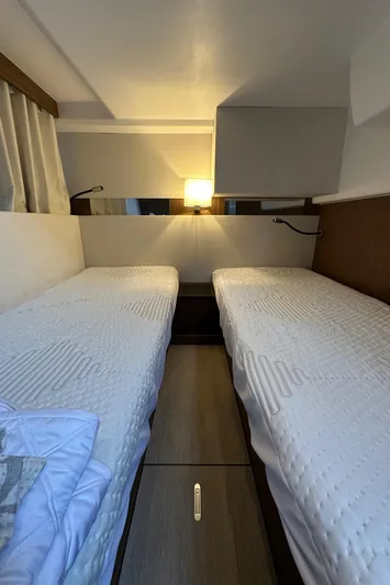 Yacht Photos Pics Cozy twin cabin in 2019 Jeanneau Velasco 37F yacht, featuring modern lighting and bedding.