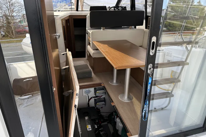  Yacht Photos Pics Interior view of 2019 Jeanneau Velasco 37F yacht, featuring seating and table area.