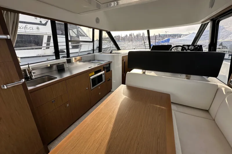  Yacht Photos Pics Interior of 2019 Jeanneau Velasco 37F yacht with modern kitchen and seating area.