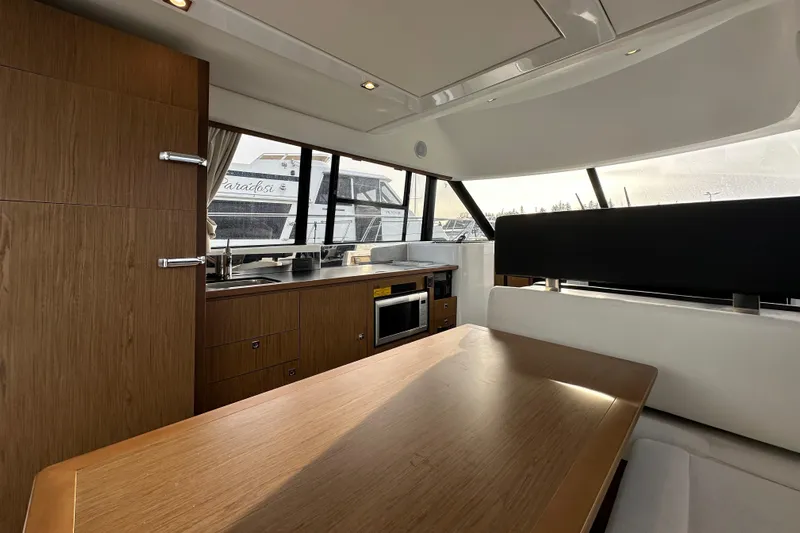  Yacht Photos Pics Interior of 2019 Jeanneau Velasco 37F yacht with modern kitchen and dining area.