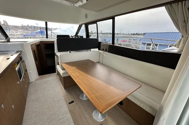 Yacht Photos Pics 2019 Jeanneau Velasco 37F interior with dining area and panoramic windows.