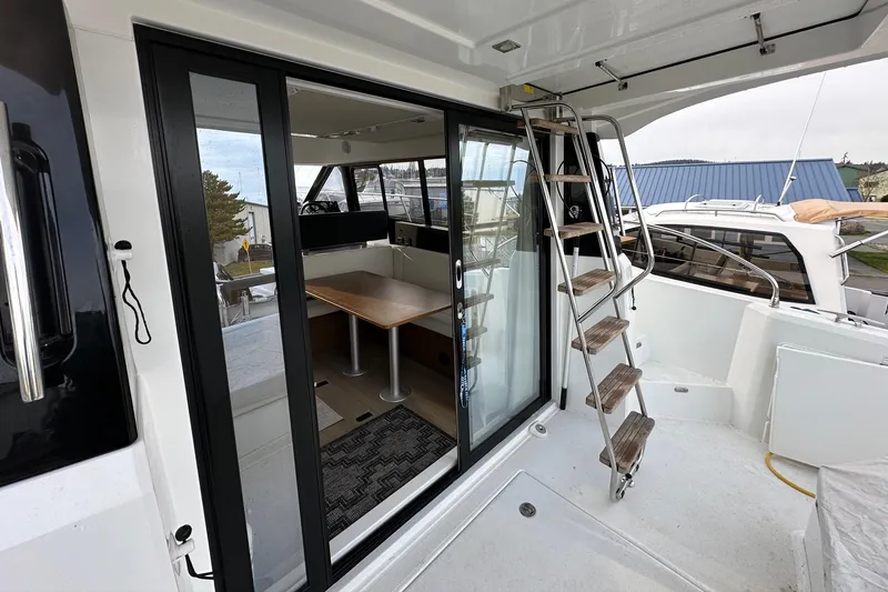  Yacht Photos Pics 2019 Jeanneau Velasco 37F yacht with sliding glass doors and exterior staircase.