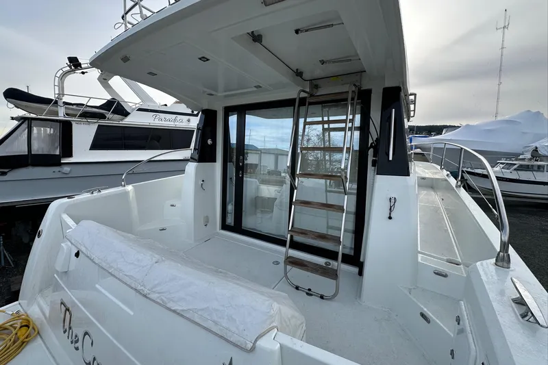  Yacht Photos Pics 2019 Jeanneau Velasco 37F yacht with spacious deck and ladder, docked at marina.