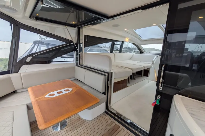 Tender Garage & Hi/lo Swimplatform Yacht Photos Pics Luxurious interior of 2022 Fairline Targa 45 GT yacht with elegant seating and wooden table.