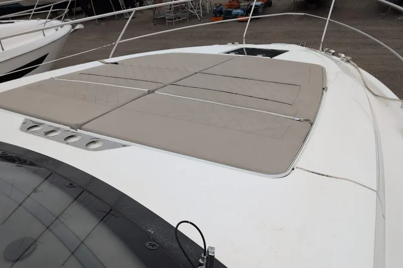 Tender Garage & Hi/lo Swimplatform Yacht Photos Pics 2022 Fairline Targa 45 GT yacht with beige sunbathing cushions on deck.