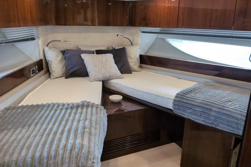 Tender Garage & Hi/lo Swimplatform Yacht Photos Pics Luxurious cabin interior of 2022 Fairline Targa 45 GT yacht with twin beds and elegant decor.