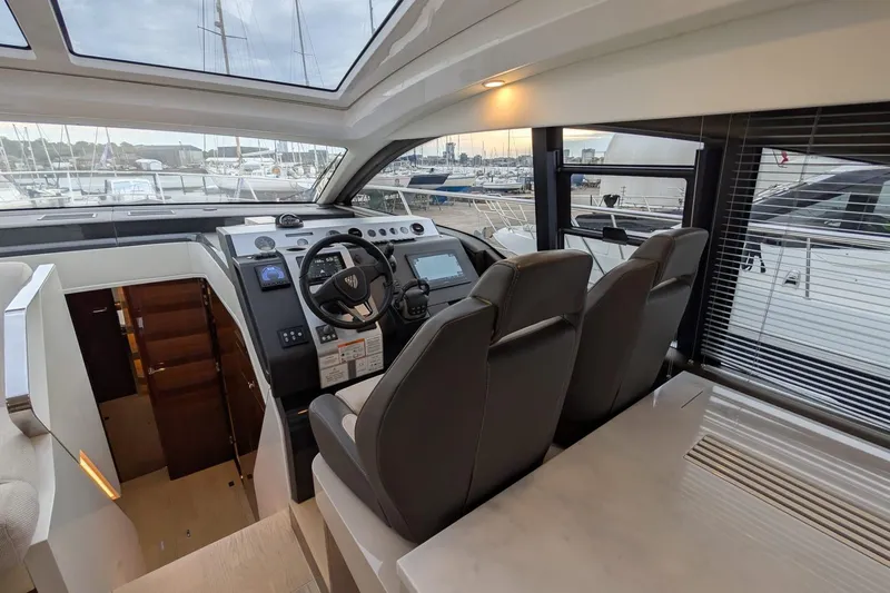 Tender Garage & Hi/lo Swimplatform Yacht Photos Pics Interior view of 2022 Fairline Targa 45 GT yacht cockpit with modern controls and seating.