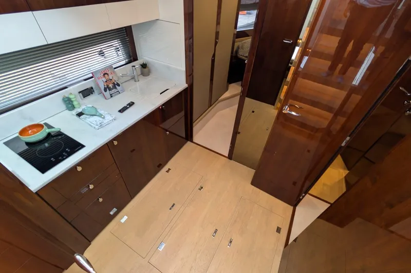 Tender Garage & Hi/lo Swimplatform Yacht Photos Pics Modern kitchen interior of 2022 Fairline Targa 45 GT yacht, featuring sleek cabinetry and appliances.