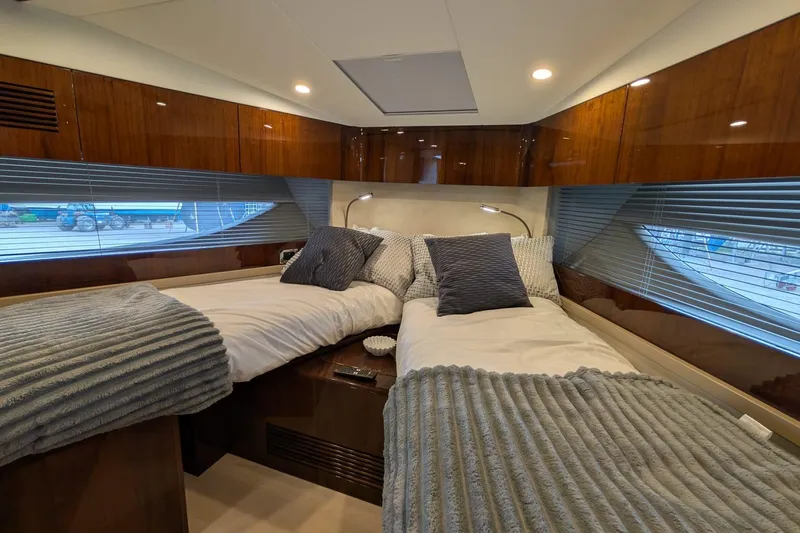 Tender Garage & Hi/lo Swimplatform Yacht Photos Pics Luxurious 2022 Fairline Targa 45 GT cabin with twin beds and elegant wood paneling.