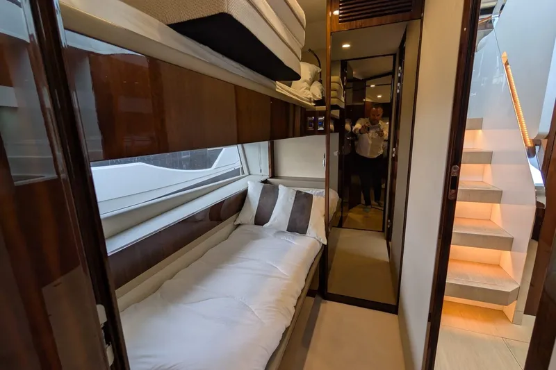 Tender Garage & Hi/lo Swimplatform Yacht Photos Pics Luxurious cabin interior of 2022 Fairline Targa 45 GT yacht with modern design and cozy bedding.