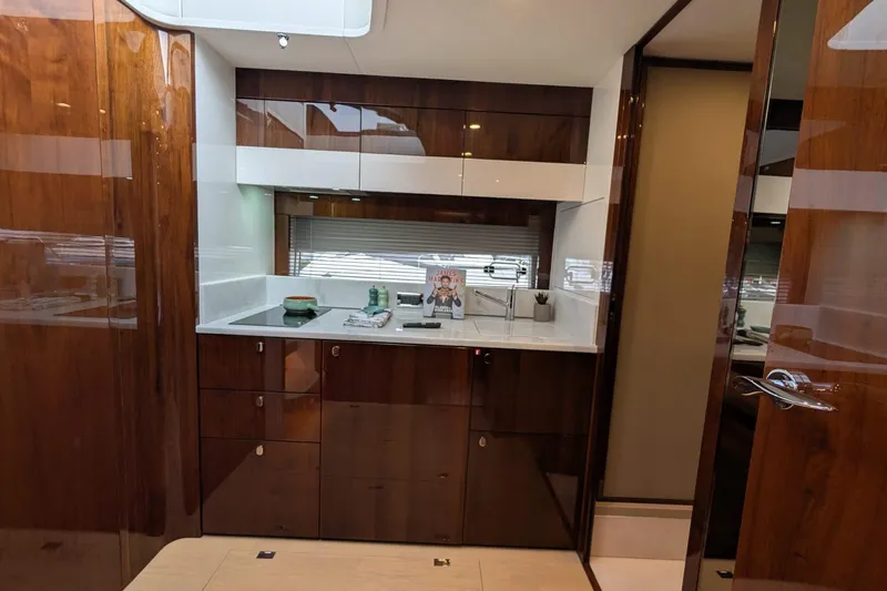 Tender Garage & Hi/lo Swimplatform Yacht Photos Pics Luxurious interior of 2022 Fairline Targa 45 GT yacht kitchen with sleek wood cabinetry.