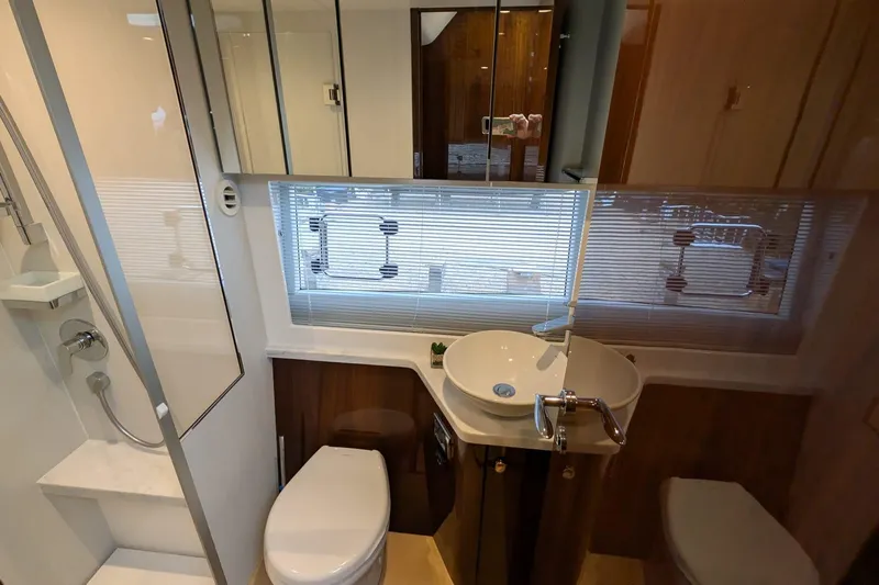 Tender Garage & Hi/lo Swimplatform Yacht Photos Pics Modern bathroom in 2022 Fairline Targa 45 GT yacht with sink, toilet, and shower.