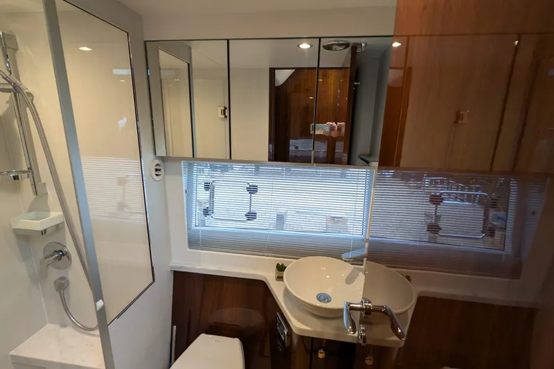 Tender Garage & Hi/lo Swimplatform Yacht Photos Pics Luxurious bathroom interior of 2022 Fairline Targa 45 GT yacht, featuring modern fixtures and elegant design.