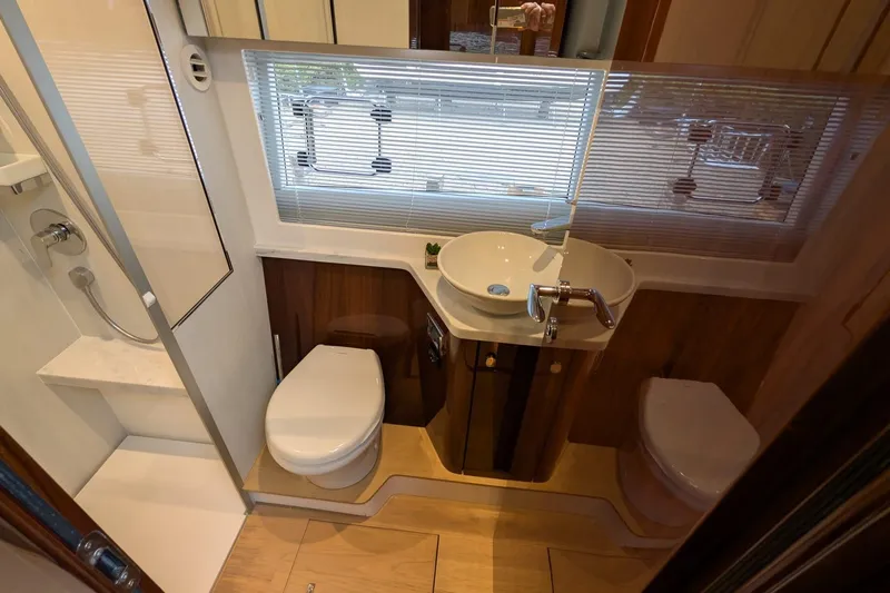 Tender Garage & Hi/lo Swimplatform Yacht Photos Pics Luxurious bathroom in 2022 Fairline Targa 45 GT yacht, featuring modern fixtures and elegant design.