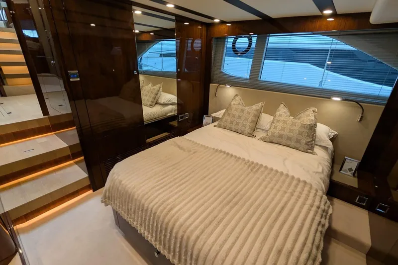 Tender Garage & Hi/lo Swimplatform Yacht Photos Pics Luxurious bedroom interior of 2022 Fairline Targa 45 GT yacht with elegant bedding and ambient lighting.