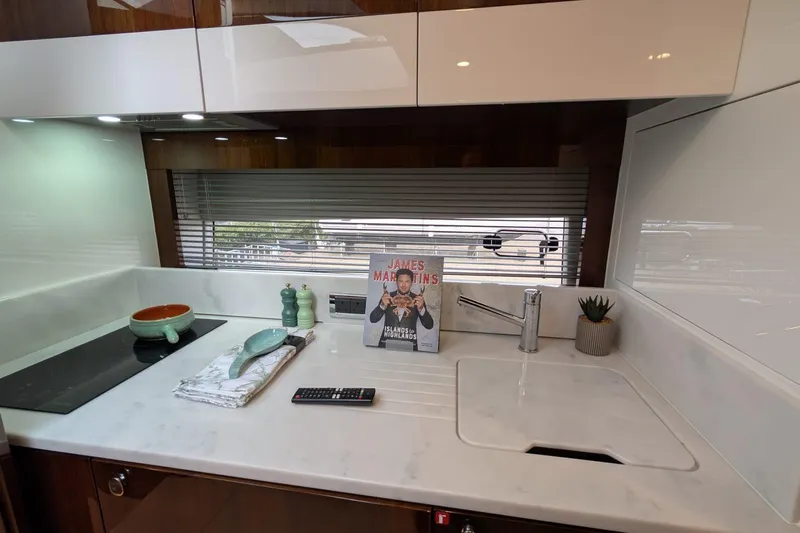 Tender Garage & Hi/lo Swimplatform Yacht Photos Pics Modern kitchen interior of 2022 Fairline Targa 45 GT yacht with sleek countertops.