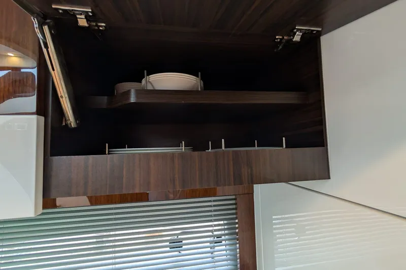 Tender Garage & Hi/lo Swimplatform Yacht Photos Pics Open cabinet in 2022 Fairline Targa 45 GT yacht, showcasing modern interior design.