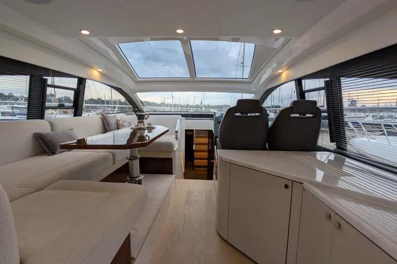 Tender Garage & Hi/lo Swimplatform Yacht Photos Pics Luxurious interior of 2022 Fairline Targa 45 GT yacht with panoramic windows and elegant seating.
