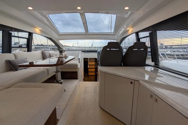 Tender Garage & Hi/lo Swimplatform Yacht Photos Pics Luxurious interior of 2022 Fairline Targa 45 GT yacht with panoramic windows and elegant seating.