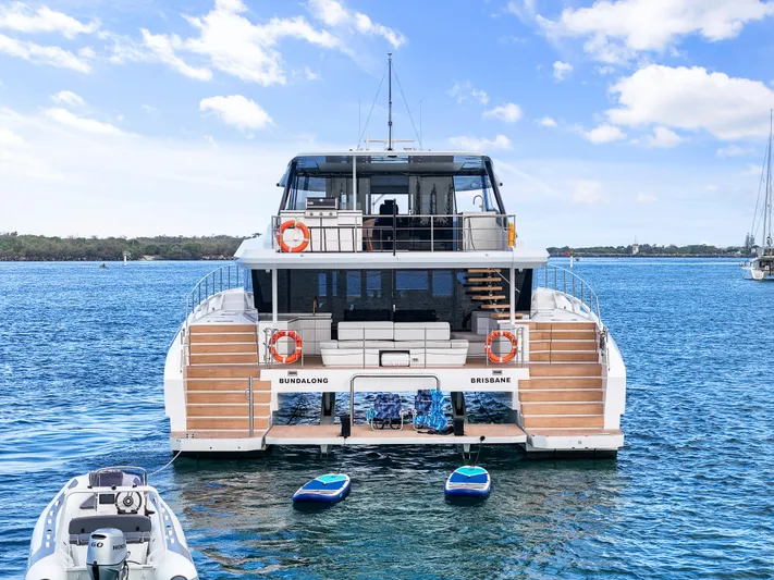 Bundalong Yacht Photos Pics Luxury McConaghy MC 82P yacht on water, 2023 model, with paddleboards and tender.
