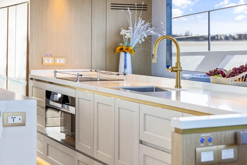 Bundalong Yacht Photos Pics Luxurious kitchen interior on 2023 McConaghy MC 82P yacht with modern appliances and elegant design.