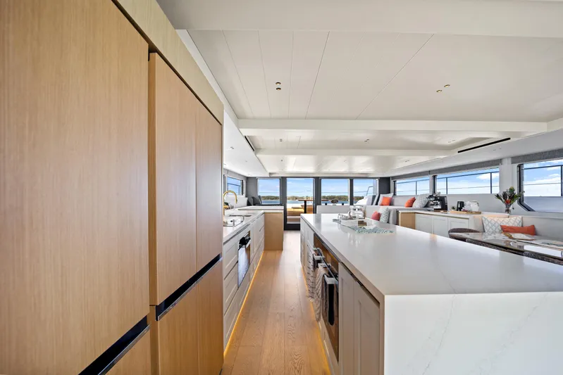 Bundalong Yacht Photos Pics Luxurious interior of 2023 McConaghy MC 82P yacht with modern kitchen and seating area.