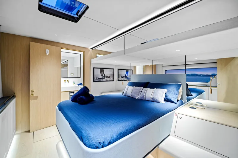 Bundalong Yacht Photos Pics Luxurious bedroom interior of 2023 McConaghy MC 82P yacht with modern design and blue accents.