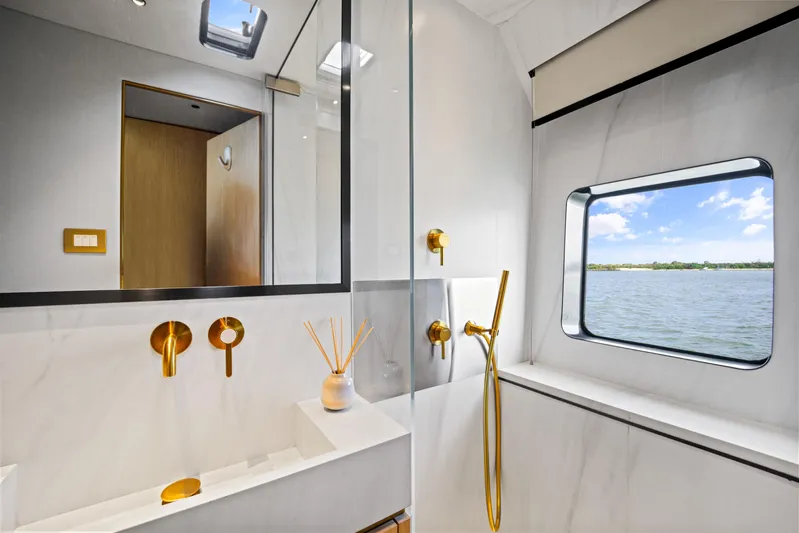 Bundalong Yacht Photos Pics Luxurious bathroom on 2023 McConaghy MC 82P yacht with gold fixtures and ocean view.