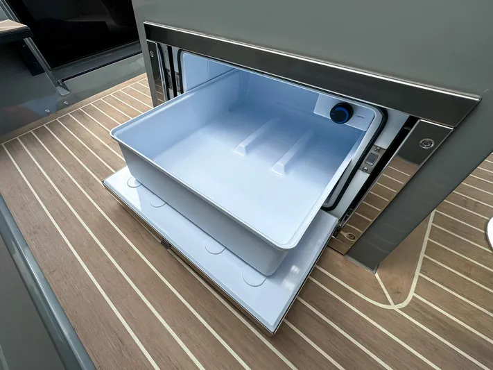  Yacht Photos Pics Open storage compartment on 2024 De Antonio Yachts D28 Cruiser with wooden flooring.