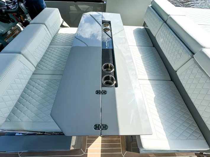  Yacht Photos Pics 2024 De Antonio Yachts D28 Cruiser interior with sleek seating and modern table design.
