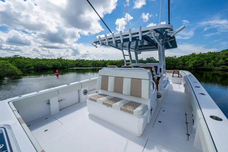 Gotta Go Yacht Photos Pics 2025 Invincible 37 Catamaran on serene water, featuring spacious deck and seating.